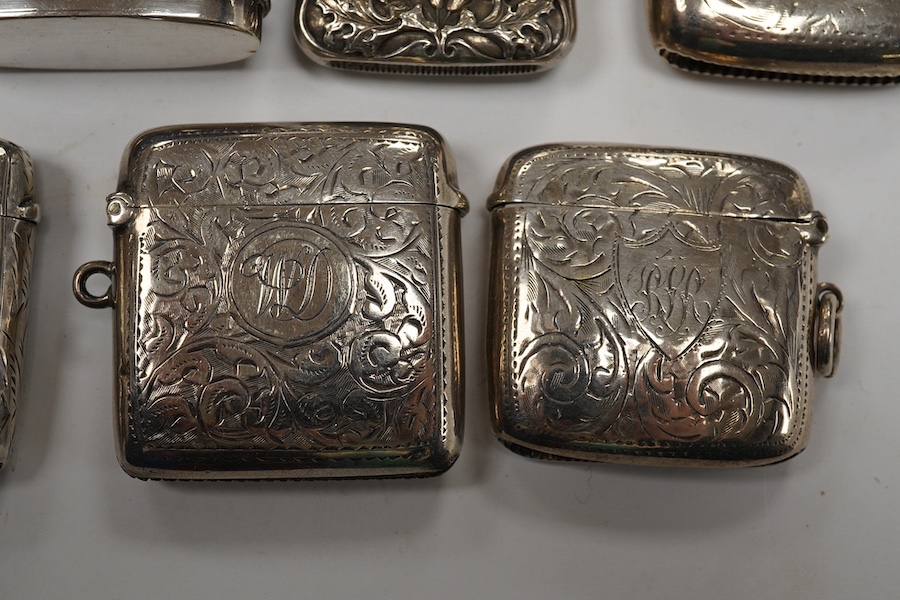 Seven assorted late 19th/early 20th century silver vesta cases, largest 48mm, a sterling case and one other pierced white metal case. Condition - poor to fair